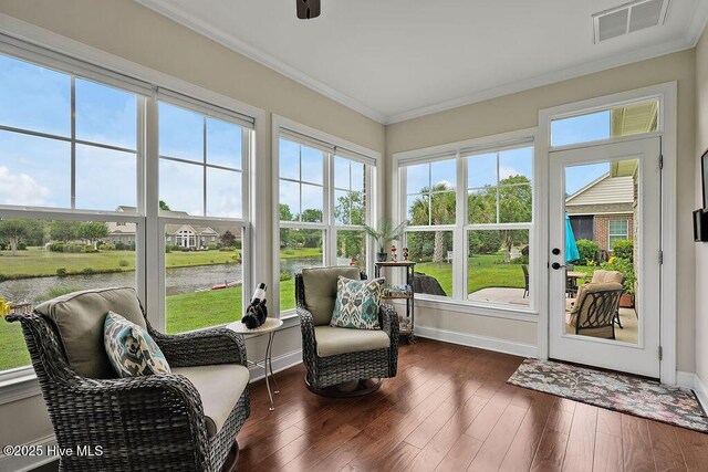 968 Woodwind Dr, Leland, NC 28451 - sunroom featuring a water view, baseboards, ornamental molding, and wood-type flooring