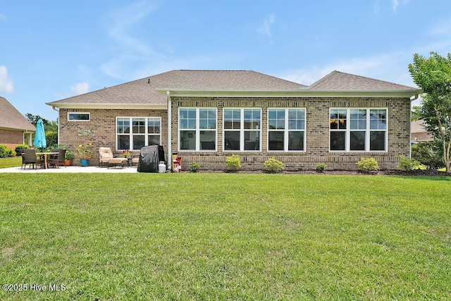 968 Woodwind Dr, Leland, NC 28451 - rear view of property featuring brick siding, a patio, a lawn, and a shingled roof