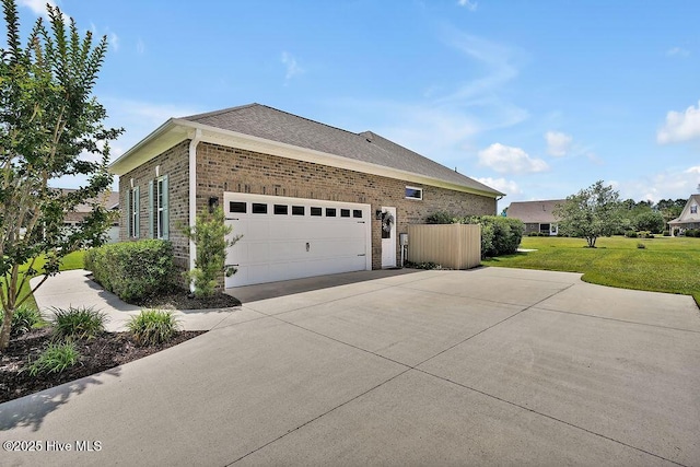 968 Woodwind Dr, Leland, NC 28451 - view of home's exterior featuring driveway, a lawn, a garage, and brick siding