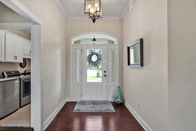 968 Woodwind Dr, Leland, NC 28451 - foyer featuring washing machine and dryer, a chandelier, baseboards, wood finished floors, and ornamental molding