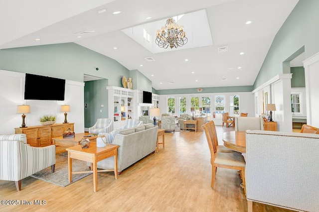 968 Woodwind Dr, Leland, NC 28451 - living area featuring high vaulted ceiling, a chandelier, light wood-type flooring, and recessed lighting