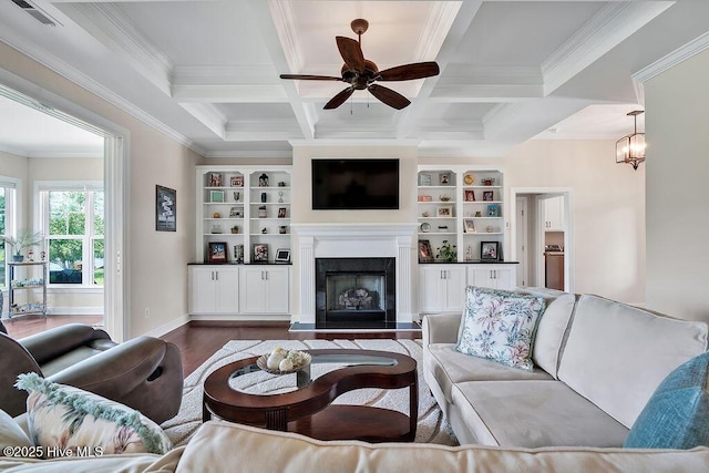 968 Woodwind Dr, Leland, NC 28451 - living area with wood finished floors, a ceiling fan, a fireplace, ornamental molding, and beamed ceiling