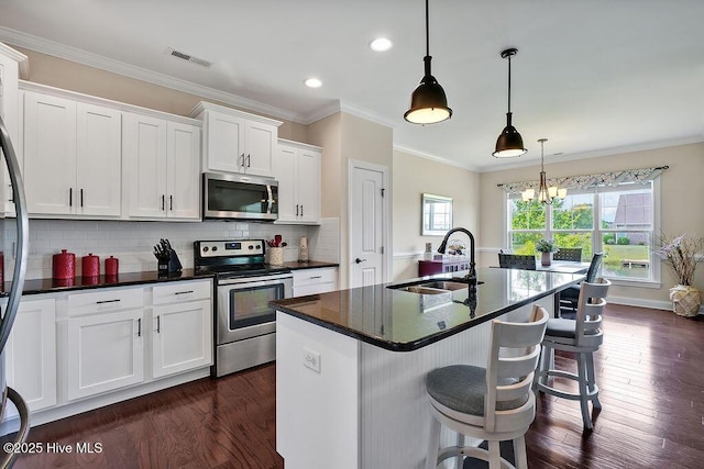 968 Woodwind Dr, Leland, NC 28451 - kitchen with appliances with stainless steel finishes, a sink, dark wood-style flooring, white cabinets, and tasteful backsplash