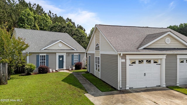 133 Moses Griffin Ln, New Bern, NC 28562 - view of front facade with a front lawn, a shingled roof, driveway, and an attached garage