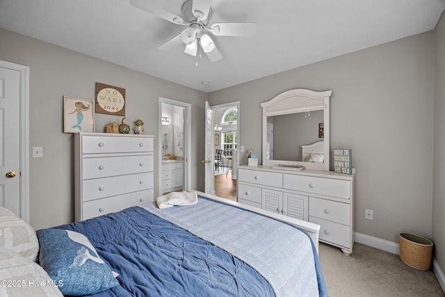 133 Moses Griffin Ln, New Bern, NC 28562 - bedroom with light colored carpet, baseboards, a ceiling fan, and ensuite bath