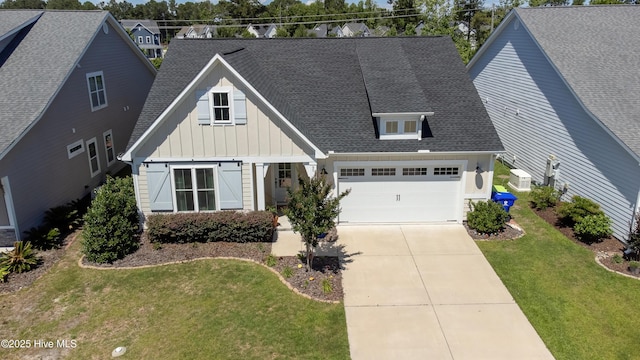 90 N Lamplighters Walk, Hampstead, NC 28443 - view of front of home featuring board and batten siding, a garage, driveway, a front yard, and roof with shingles