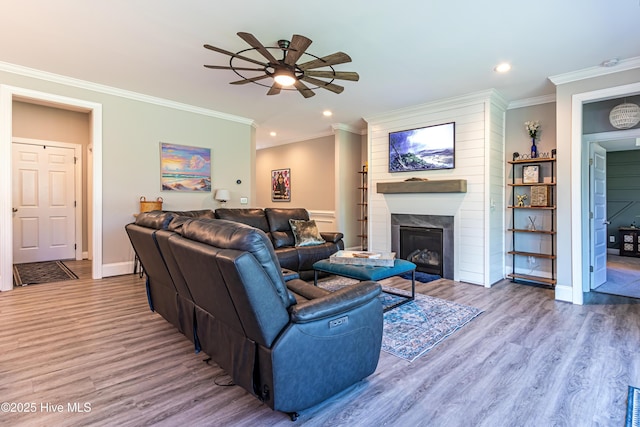 90 N Lamplighters Walk, Hampstead, NC 28443 - living area with a ceiling fan, wood finished floors, a large fireplace, ornamental molding, and recessed lighting