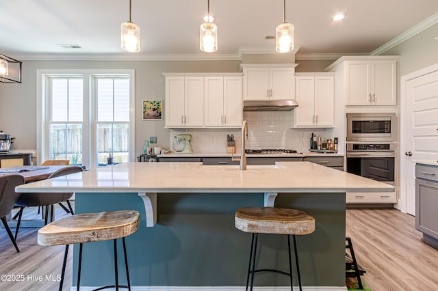90 N Lamplighters Walk, Hampstead, NC 28443 - kitchen featuring stainless steel appliances, under cabinet range hood, ornamental molding, backsplash, and a sink