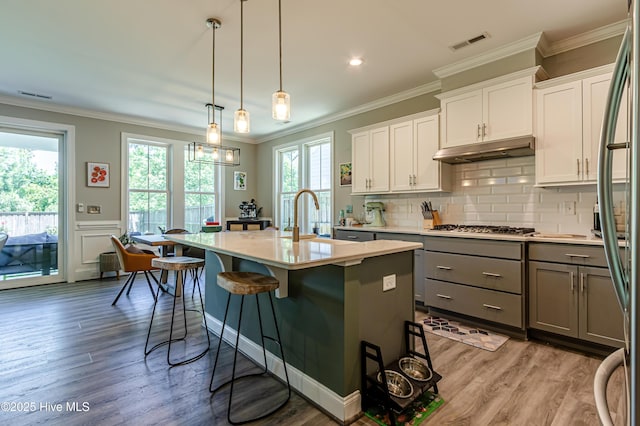 90 N Lamplighters Walk, Hampstead, NC 28443 - kitchen featuring gray cabinets, under cabinet range hood, light countertops, stainless steel appliances, and a sink
