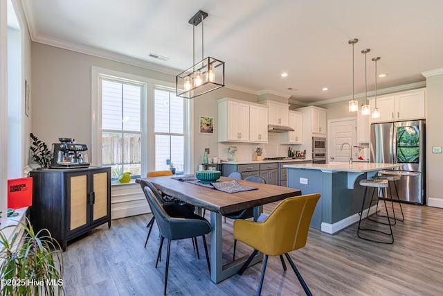 90 N Lamplighters Walk, Hampstead, NC 28443 - dining space featuring ornamental molding, a chandelier, light wood finished floors, and recessed lighting