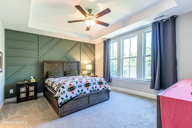 90 N Lamplighters Walk, Hampstead, NC 28443 - carpeted bedroom featuring a tray ceiling, crown molding, a decorative wall, baseboards, and ceiling fan