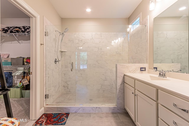 90 N Lamplighters Walk, Hampstead, NC 28443 - bathroom with a stall shower, vanity, a spacious closet, and recessed lighting
