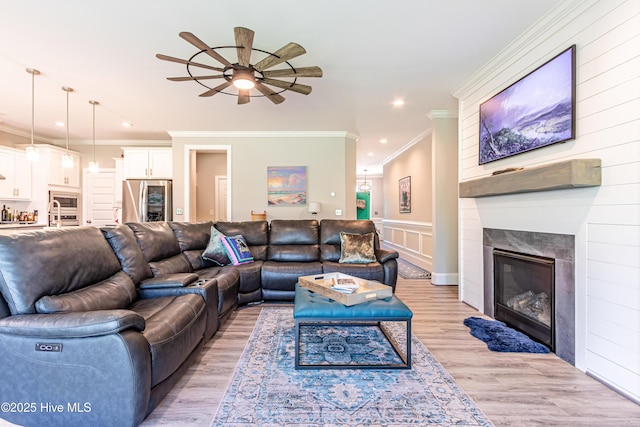 90 N Lamplighters Walk, Hampstead, NC 28443 - living area featuring a ceiling fan, crown molding, recessed lighting, light wood finished floors, and a glass covered fireplace