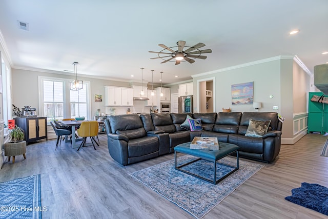 90 N Lamplighters Walk, Hampstead, NC 28443 - living room with light wood finished floors, ornamental molding, recessed lighting, ceiling fan, and baseboards