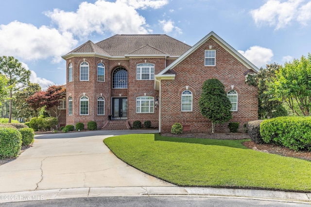 6575 Longwater Ct SW, Ocean Isle Beach, NC 28469 - colonial inspired home with a front yard, brick siding, and concrete driveway