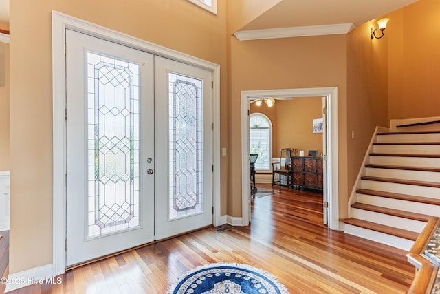 6575 Longwater Ct SW, Ocean Isle Beach, NC 28469 - foyer featuring light wood-style flooring, stairs, baseboards, and crown molding