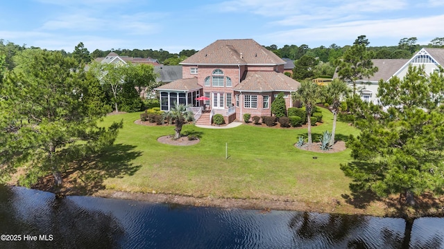 6575 Longwater Ct SW, Ocean Isle Beach, NC 28469 - back of property with a sunroom, a water view, and a yard
