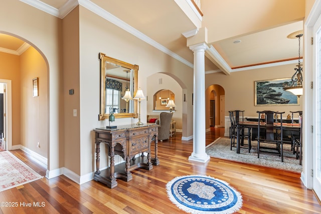 6575 Longwater Ct SW, Ocean Isle Beach, NC 28469 - foyer entrance with wood finished floors, arched walkways, crown molding, and baseboards