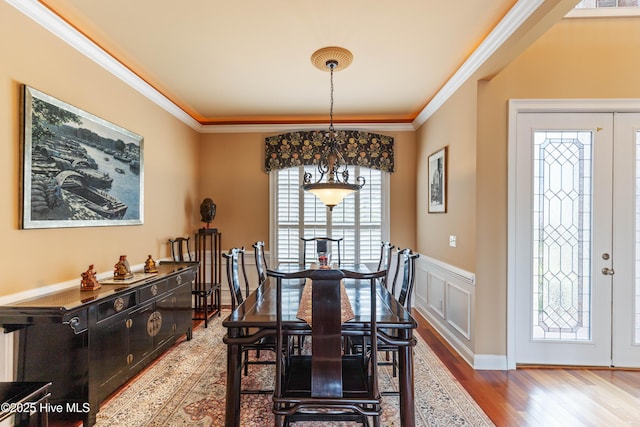 6575 Longwater Ct SW, Ocean Isle Beach, NC 28469 - dining space featuring wood finished floors, ornamental molding, and wainscoting