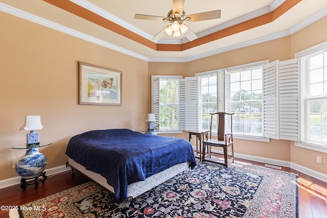 6575 Longwater Ct SW, Ocean Isle Beach, NC 28469 - bedroom with hardwood / wood-style floors, crown molding, baseboards, and ceiling fan