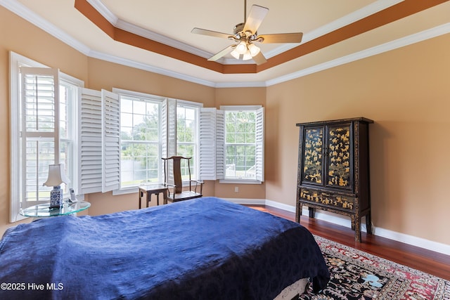 6575 Longwater Ct SW, Ocean Isle Beach, NC 28469 - bedroom featuring wood finished floors, crown molding, a raised ceiling, baseboards, and ceiling fan