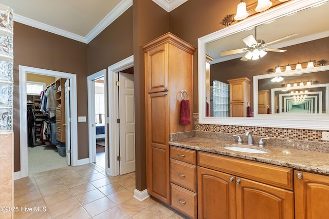 6575 Longwater Ct SW, Ocean Isle Beach, NC 28469 - bathroom with ceiling fan, vanity, crown molding, tile patterned flooring, and baseboards