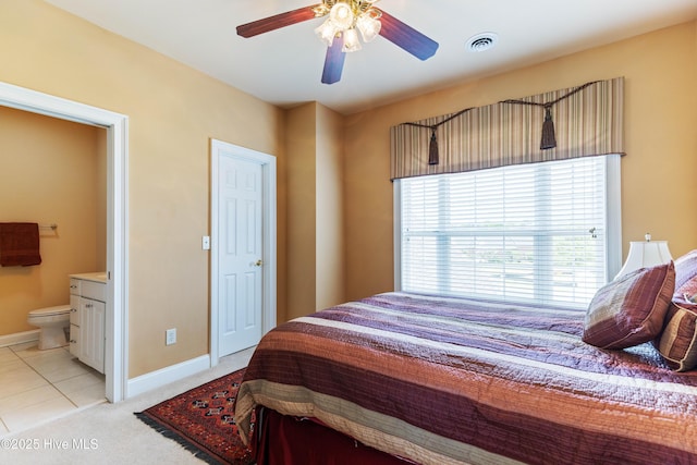 6575 Longwater Ct SW, Ocean Isle Beach, NC 28469 - bedroom with ensuite bathroom, baseboards, light colored carpet, a ceiling fan, and light tile patterned floors
