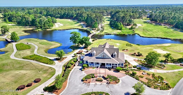 6575 Longwater Ct SW, Ocean Isle Beach, NC 28469 - drone / aerial view of a heavily wooded area, a local golf course, and a nearby body of water