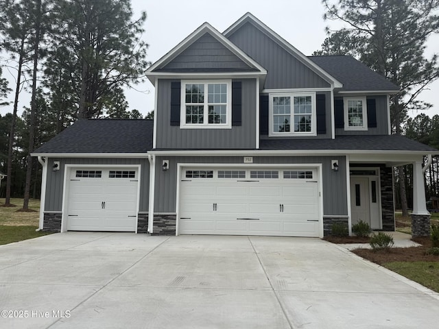 craftsman house with stone siding, concrete driveway, a garage, and a shingled roof