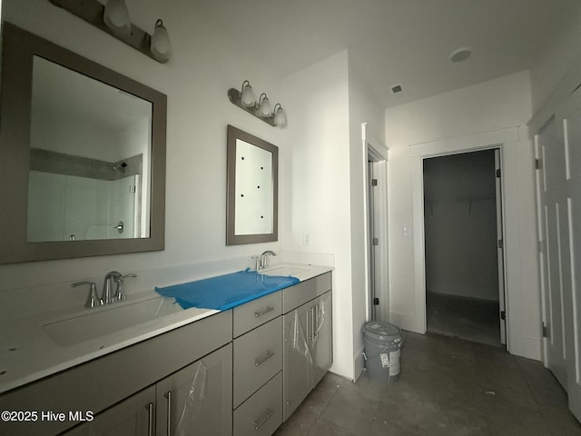 full bath featuring toilet, double vanity, and a shower