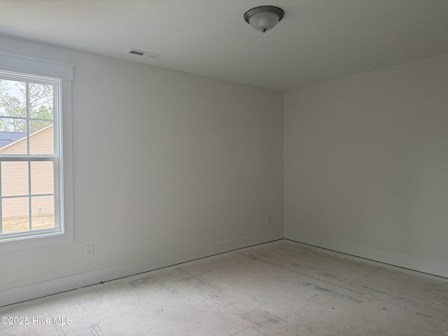 spare room with baseboards