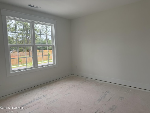 unfurnished room featuring baseboards