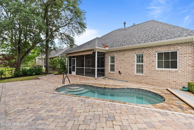 view of swimming pool featuring a sunroom, a patio, and fence