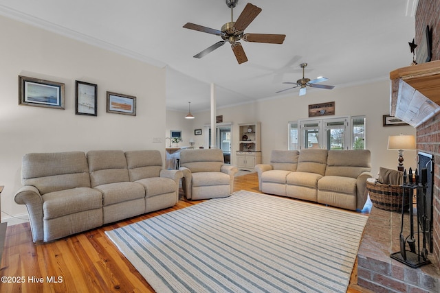 101 Mallard Dr, Currituck, NC 27929 - living area with wood finished floors, crown molding, a ceiling fan, and a fireplace