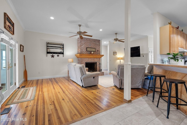 101 Mallard Dr, Currituck, NC 27929 - living room featuring ornamental molding, recessed lighting, a brick fireplace, ceiling fan, and light wood-type flooring