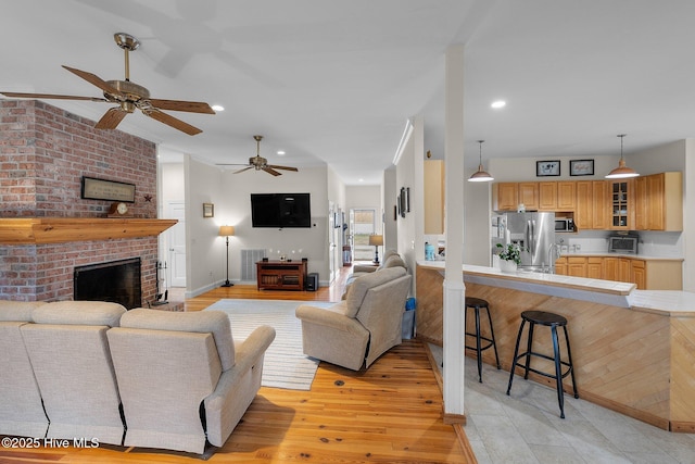 101 Mallard Dr, Currituck, NC 27929 - living area featuring a ceiling fan, light wood-style floors, a brick fireplace, and recessed lighting