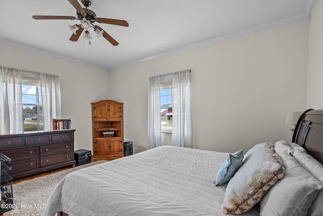 101 Mallard Dr, Currituck, NC 27929 - bedroom with crown molding, multiple windows, wood finished floors, and ceiling fan