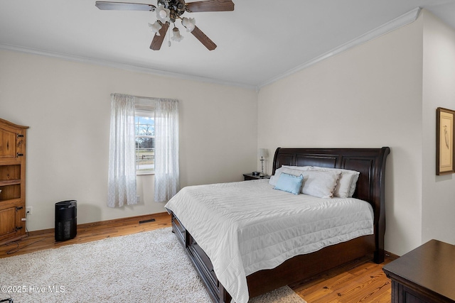 101 Mallard Dr, Currituck, NC 27929 - bedroom featuring crown molding, light wood-style flooring, and a ceiling fan