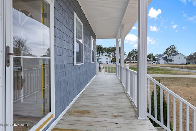 101 Mallard Dr, Currituck, NC 27929 - wooden deck featuring covered porch and a residential view