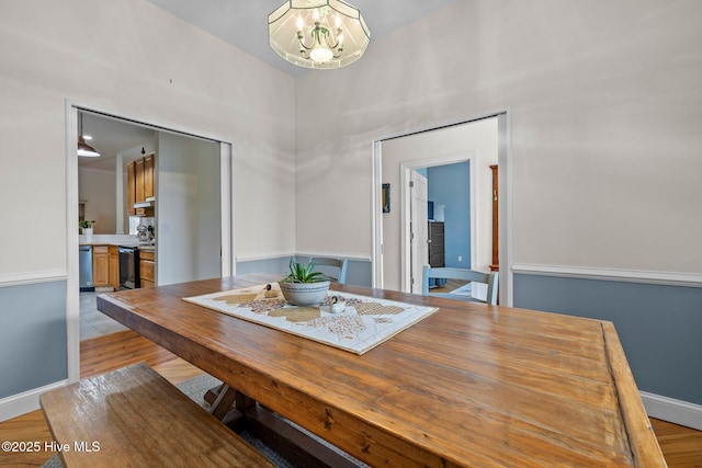 101 Mallard Dr, Currituck, NC 27929 - dining area featuring a chandelier, light wood-style flooring, and baseboards