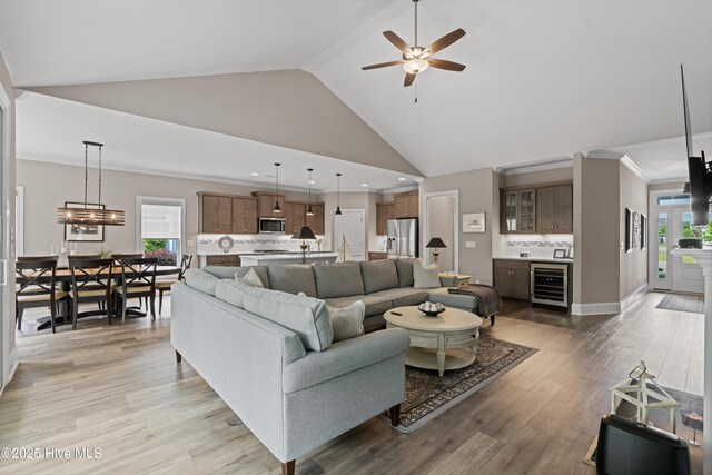 3032 Beachcomber Dr, Southport, NC 28461 - living area with beverage cooler, a ceiling fan, bar area, light wood-type flooring, and recessed lighting