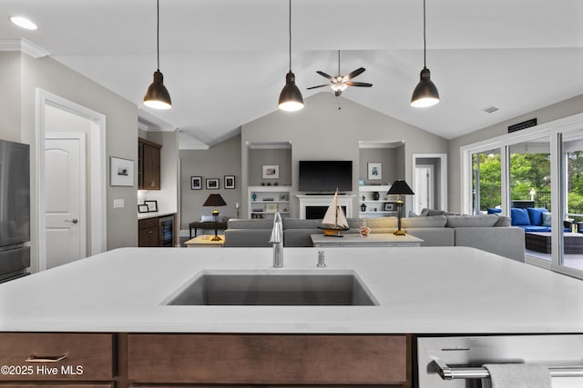 3032 Beachcomber Dr, Southport, NC 28461 - kitchen featuring open floor plan, a sink, lofted ceiling, ceiling fan, and hanging light fixtures