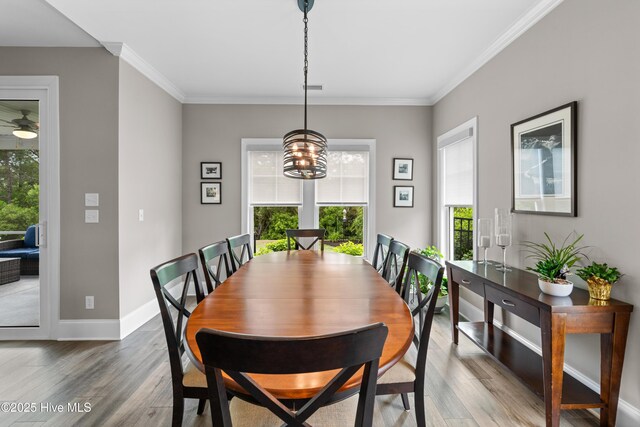 3032 Beachcomber Dr, Southport, NC 28461 - dining area featuring wood finished floors, ornamental molding, a chandelier, and baseboards