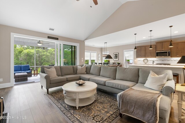 3032 Beachcomber Dr, Southport, NC 28461 - living area with a ceiling fan, light wood-type flooring, recessed lighting, and high vaulted ceiling