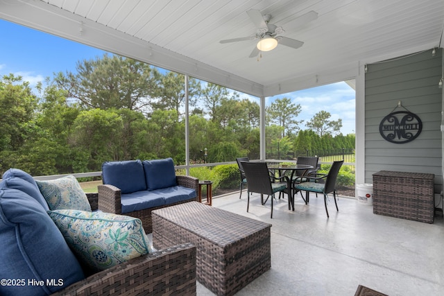 3032 Beachcomber Dr, Southport, NC 28461 - sunroom with outdoor lounge area, outdoor dining area, a ceiling fan, and view of wooded area