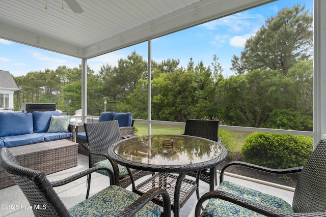 3032 Beachcomber Dr, Southport, NC 28461 - sunroom with ceiling fan, outdoor lounge area, outdoor dining space, and view of scattered trees
