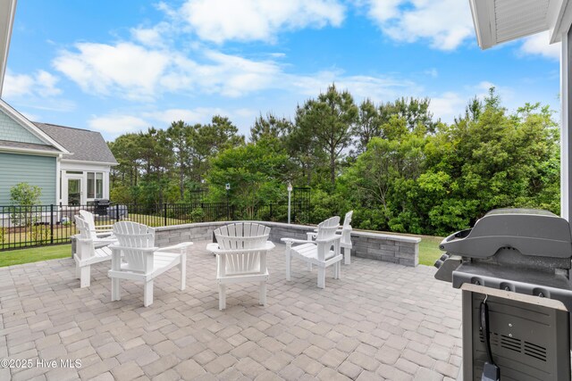 3032 Beachcomber Dr, Southport, NC 28461 - view of patio / terrace with fence, view of wooded area, and grilling area