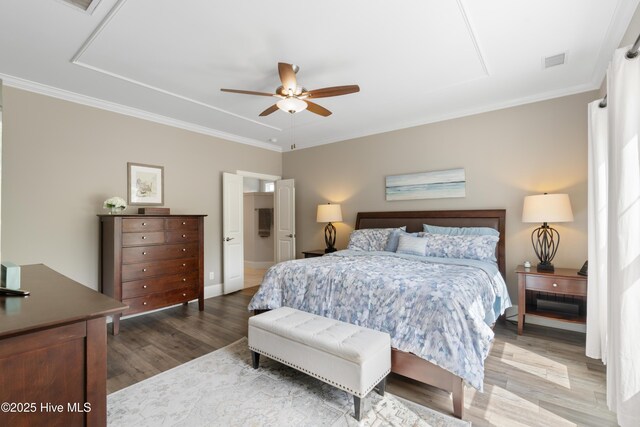 3032 Beachcomber Dr, Southport, NC 28461 - bedroom featuring wood finished floors, ornamental molding, a ceiling fan, and baseboards