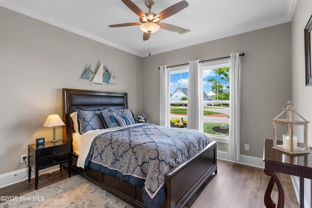 3032 Beachcomber Dr, Southport, NC 28461 - bedroom featuring baseboards, wood finished floors, crown molding, and a ceiling fan