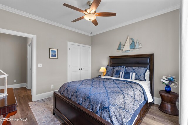 3032 Beachcomber Dr, Southport, NC 28461 - bedroom featuring wood finished floors, a closet, baseboards, ornamental molding, and ceiling fan
